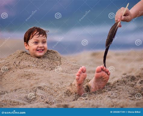 buried in sand and tickled|Xenia buried in the sand and Tickled by Gabbi ! Public beach tickle.